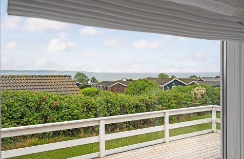 Helnæs By House | A simple cottage with terrace and bright living room.