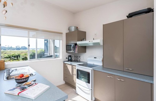 Mangawhai House | Back Bay Beauty - Sunny, pet-friendly kiwi bach with lovely estuary views and access