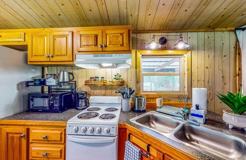 Waller Cabin | Cedar cabin with pretty pond, beach, swimming deck & tropical hut/bar