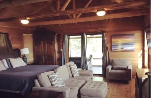 Prairie Lea House | Charming Log Cabin in Texas - Perfect Glamping Vacation on the San Marcos River near Kingsbury