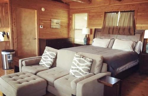 Prairie Lea House | Charming Log Cabin in Texas - Perfect Glamping Vacation on the San Marcos River near Kingsbury