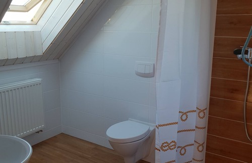 Powidz Apartment | Comfortable rooms near the lake.