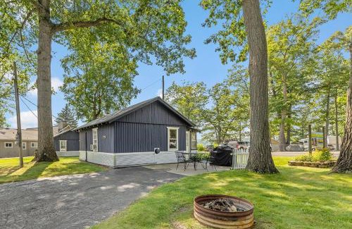 Newaygo Apartment | Cozy pet-friendly cabin with dock, firepit, bikes, BBQ