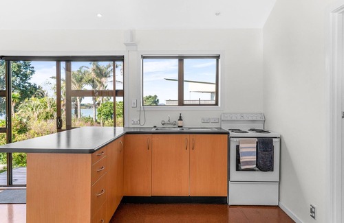 Mangawhai Heads House | Dune Views - Sunny, quirky kiwi bach with estuary views