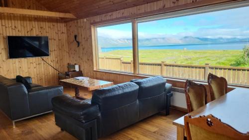 Arnarstapi House | Glass House with Private River & 360° Views