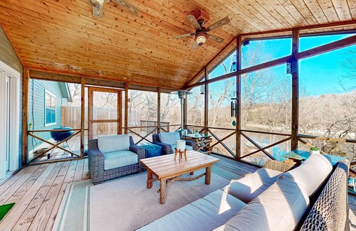 Powell House | Lakefront retreat with screened sunroom, wood stove, multiple decks, & AC