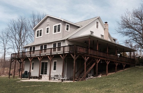 Dundee House | Large Lakefront Reunion And Retreat Home With a large lawn and wrap around porch
