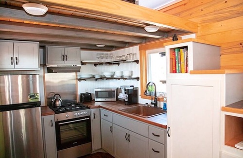 Meeker House | Lion Canyon was built by Mitchcraft in Fort Collins, Colorado as part of HGTV's "Tiny House Hunters". This home has two lofts, each with a Queen bed. One is accessible by stairs and one by ladder.