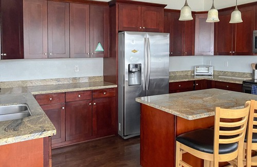 South Colby House | Luxury bayfront home with beach access, deck & gas fireplace - great for events