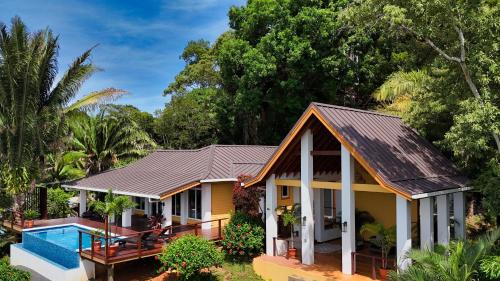 Gibson Bight House | Relax At This Hillside Retreat That Overlooks The Lush Forest And The Caribbean,