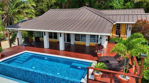 Gibson Bight House | Relax At This Hillside Retreat That Overlooks The Lush Forest And The Caribbean,