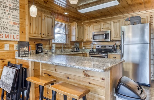 Gatlinburg - Pigeon Forge Cabin | Rustic home w/private hot tub, free WiFi, full kitchen, & shared pool access