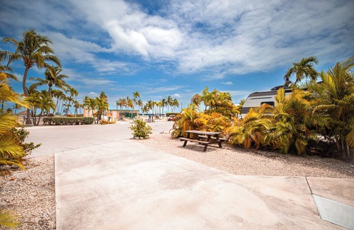 Cudjoe Key RV Rental | RV Lot 303 Venture Out, Pull-through Lot near the Ocean and Pool - Bring your golf cart!