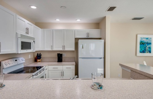 South Island House | Sand Dollar #4 - Upstairs Apt with shared Pool on Canal by the Beach!