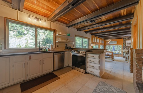 Salyer House | Stunning riverfront gem w/wraparound deck, beach access & game room