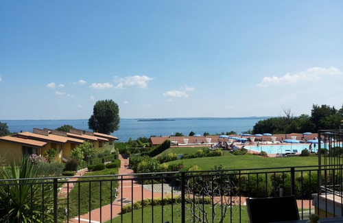 Manerba del Garda Apartment | Stunning three-room lake view in a residence with three swimming pools and 36,000 m2 of greenery