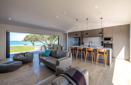 Blackpool House | The Golden Pohutukawa - Beach House - The Golden Pohutukawa - Beach House is a newly built, premium holiday home in an absolute beach front location. With two bedrooms one king and one queen and two bathrooms, this is a wonderful option for up to 4 g
