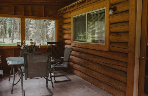 Seeley Lake Cabin | The Saddle Shed at Tamaracks Resort is a log cabin with furnished screen porch.
