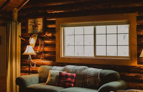 Seeley Lake Cabin | The Saddle Shed at Tamaracks Resort is a log cabin with furnished screen porch.