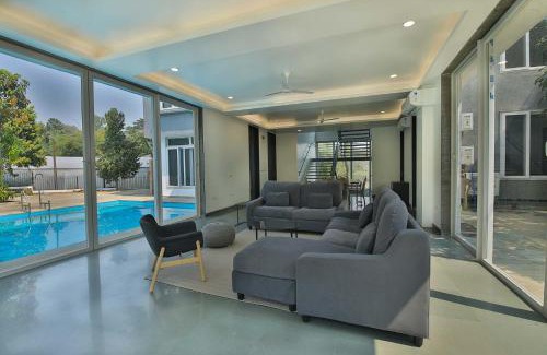 Khalapur Villa | Twilight Grove by StayVista - Pool- view villa with Manicured lawn, Contemporary interiors & Home theatre