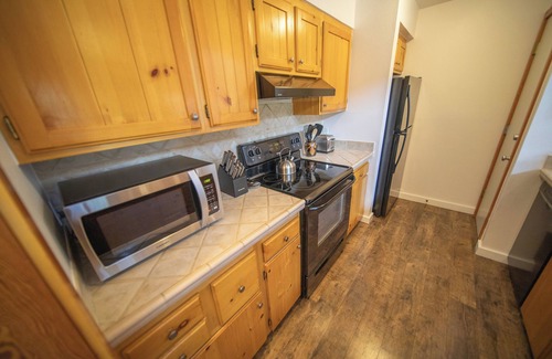 Lakeside Village Condo | Unit with wood burning fireplace and free shuttle