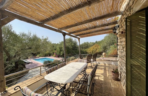Korithi Villa | Villa set within private courtyard surrounded by mature olive trees