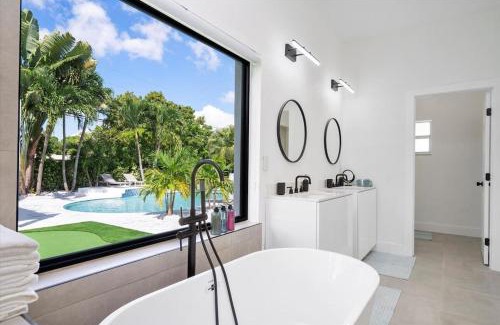 North Miami House | VillaLee-Jungle Palm Island white marble pool Area