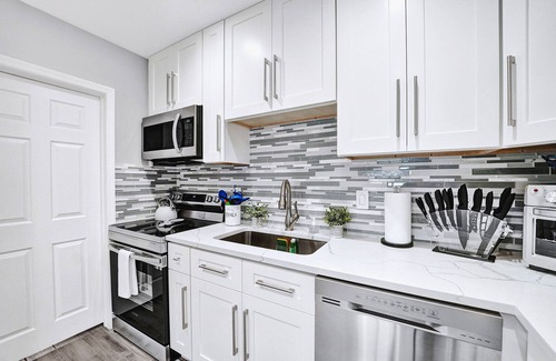 Golfview Harbor House | Waterfront Tropic Oasis: Heated Pool, Pergola, Canal, Dock, Air Hockey!
