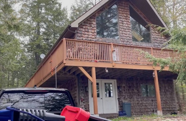 Beautiful beachfront chalet with southern exposure on Green Lake,Dedham, Maine.