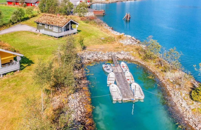 Beautiful cottages built on the fjord in Fjærland.
