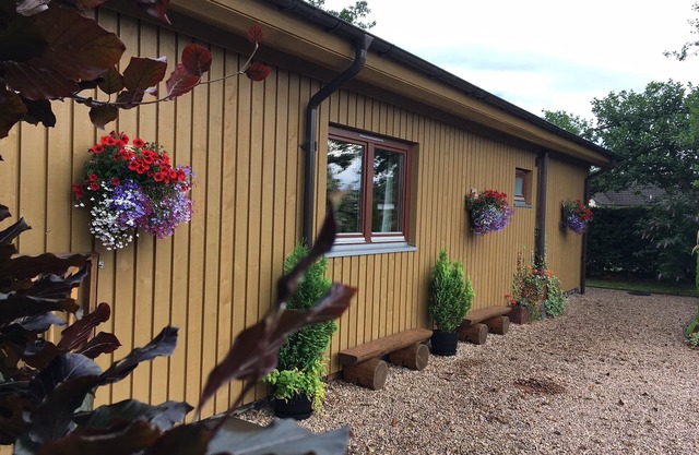 Burnside Lodge, overlooking river Lundy, backdrop of Ben Nevis and Nevis Range.