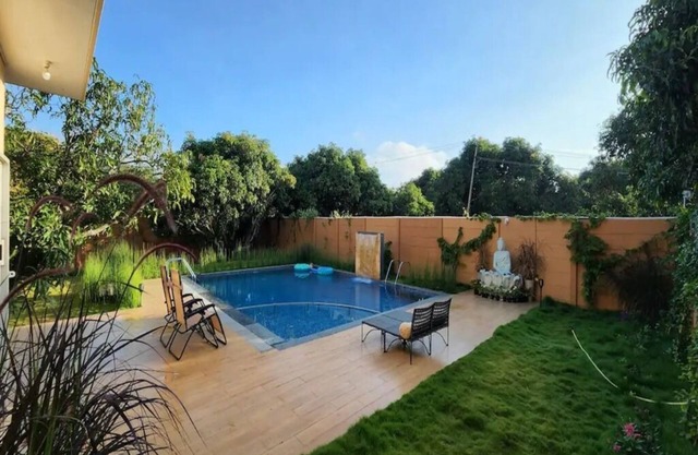 Farm with modern 3 BHK pool villa providing green retreat for urban dwellers.