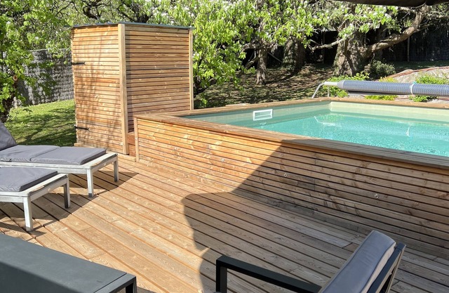 In a green setting, my wooden house with its private swimming pool