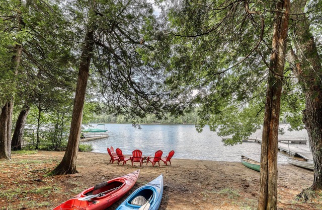 Inviting lakefront house with dock, sandy beach & screened porch