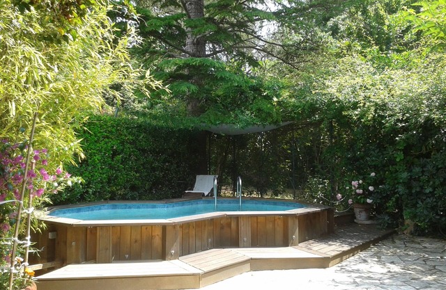 Large studio in garden with pool