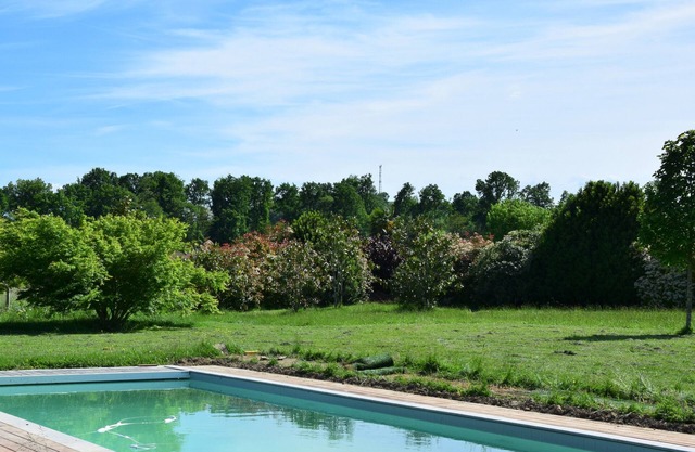 Pretty villa with a large swimming pool in lush greenery