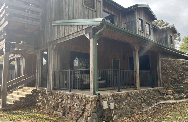 Rustic Lodge with a view of open pastures and bison grazing on the land.