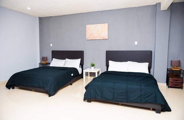 Studio suite with Two Queen Bed, Sofa and kitchen