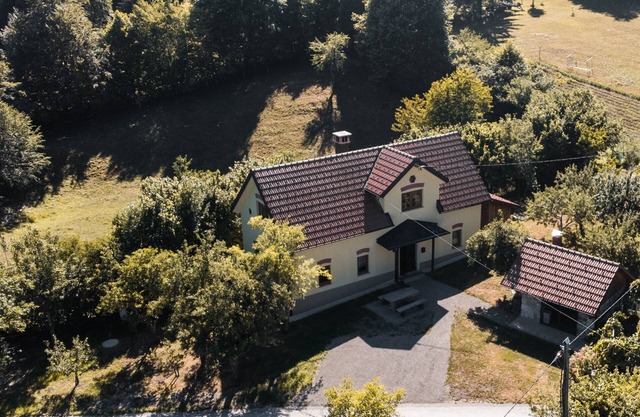 Traditional old house in a peacefull small village, surrounded by green forests.