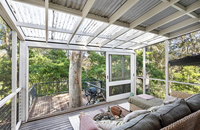 Tranquil family-sized treehouse. Ocean glimpses with outdoor deck.