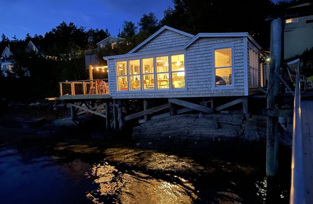 Waterfront, west facing, modernized fisherman’s cottage perched on the water.