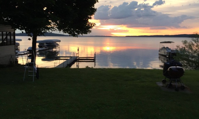 Markesan Cottage | Classic Green Lake cottage, lakefront, screened boathouse deck, dock, swimming