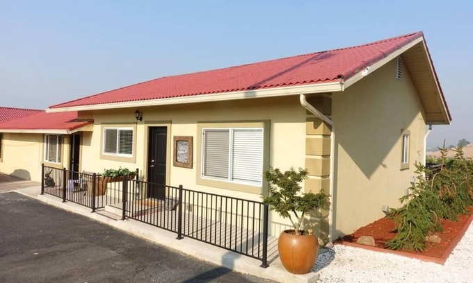 Talent Apartment | Cottage 1 offers a king-sized bed, dining area, full kitchen, hot tub.