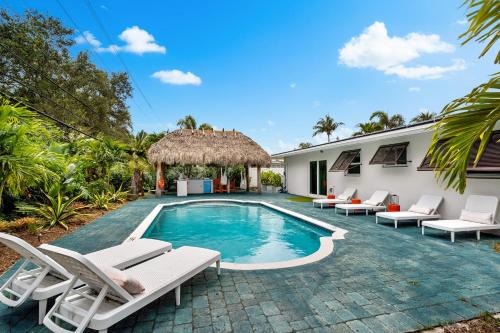Garden Isles House | Eccentric home with pool tiki hut & outdoor kitchen
