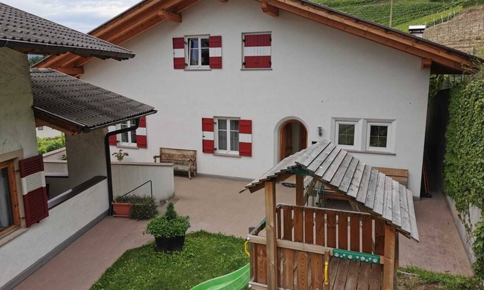Kurtatsch an der Weinstraße House | Family apartment with playground and terrace surrounded by vineyards