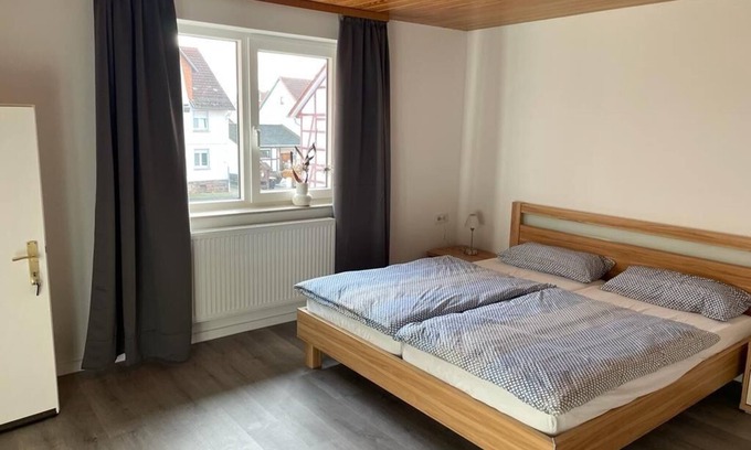 Alheim Apartment | Guest room with private bathroom, in a vacation home, centrally located