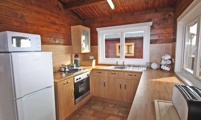 Pontardulais Cottage | Lake side log cabin peacefully situated and each enjoying fabulous lake views.