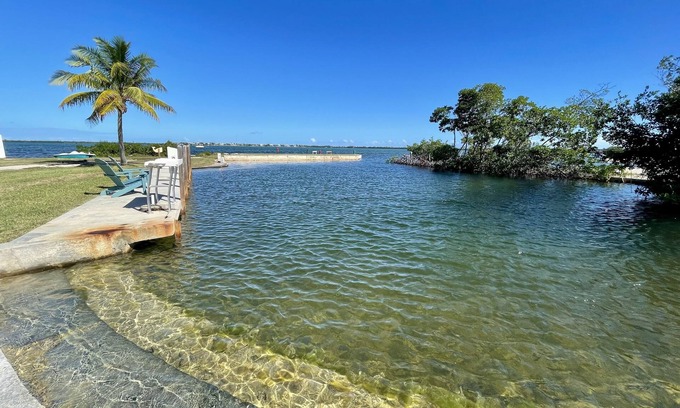Little Torch Key House | Old Florida Style, wrap around porch, boat basin for dockage, open water