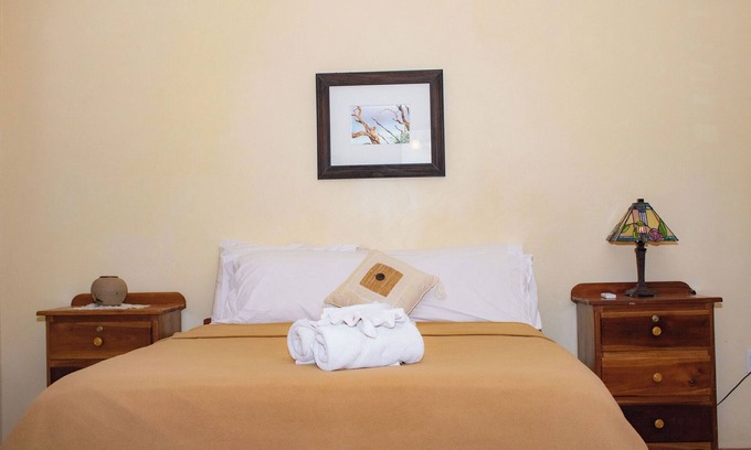 Orchid Bay Bed & Breakfast | Queen-size bed, with a private bathroom, a walk-in shower and closet.