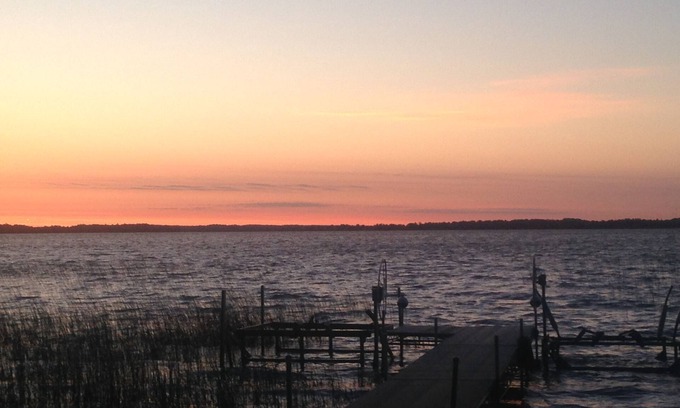 Dent House | Spectacular sunrise glistening off the lake from this quiet lakeside retreat